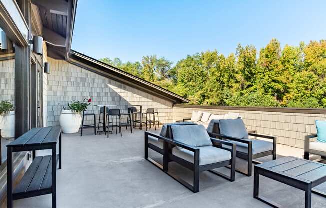 a patio with furniture and a view of trees