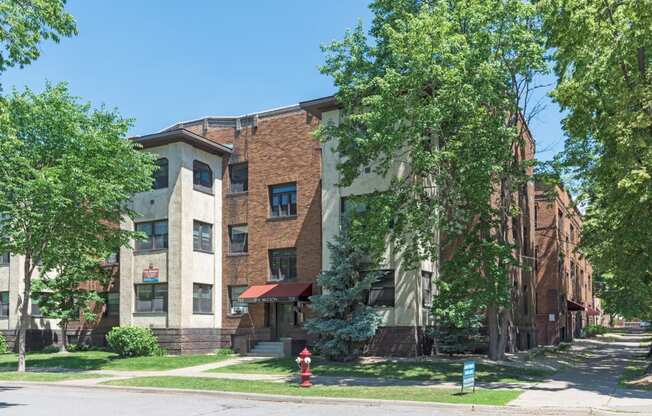 a large brick apartment building with a red fire hydrant