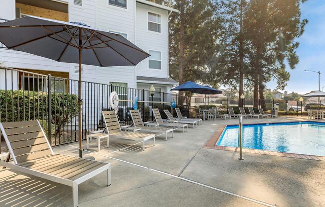 a house with a pool in front of a building