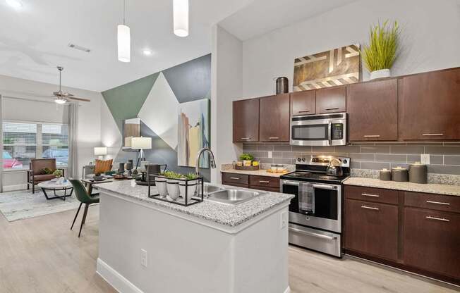 A modern kitchen with a large island and stainless steel appliances.