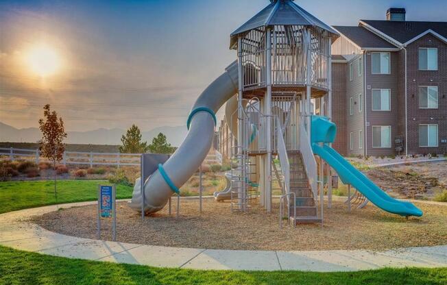 a playground with a  and a slide  at Affinity 56 Apartments in West Jordan, Utah