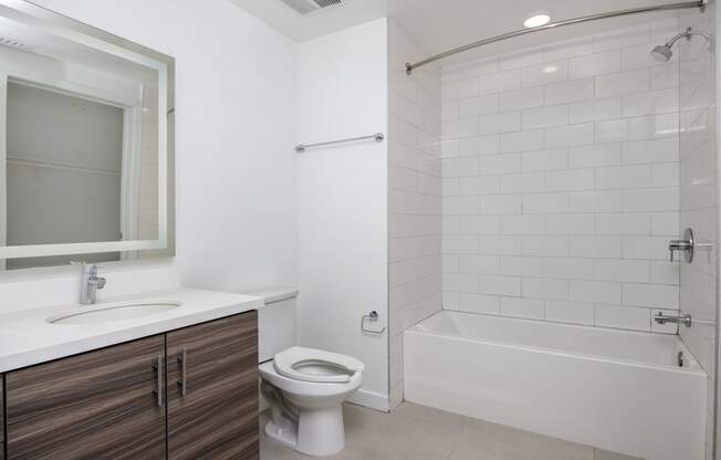 a bathroom with a toilet and a tub and a sink