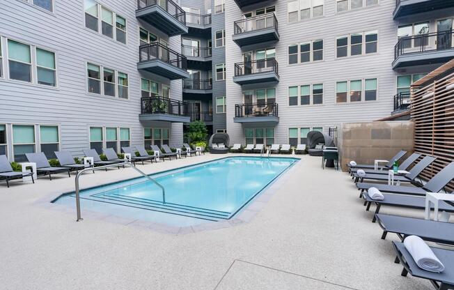 Relax by the sparkling courtyard pool—perfect for a refreshing dip or unwinding in a private lounge chair.