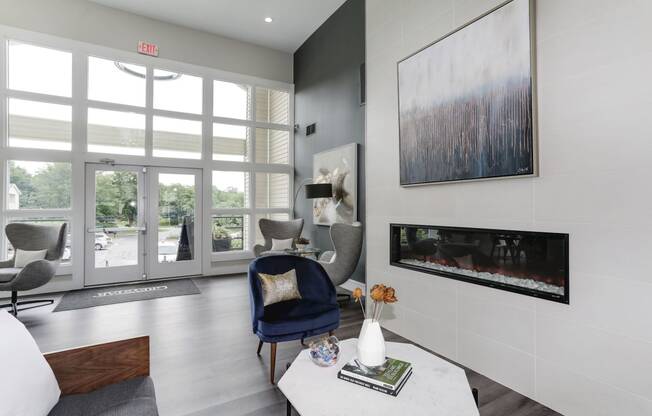 a living room with a blue chair and a white coffee table
