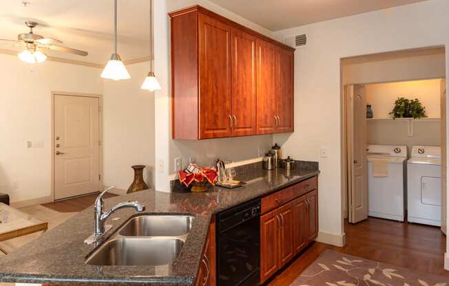 a kitchen with granite countertops and wooden cabinets