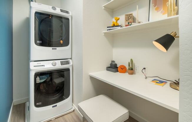 a washer and dryer are stacked on top of each other in a laundry room