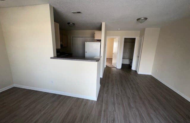 an empty living room and kitchen in an empty house