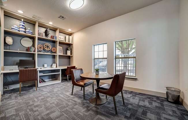 a room with a table and chairs and a bookshelf