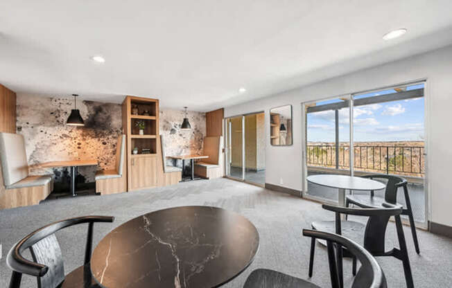 A modern living room with a black marble table and chairs.