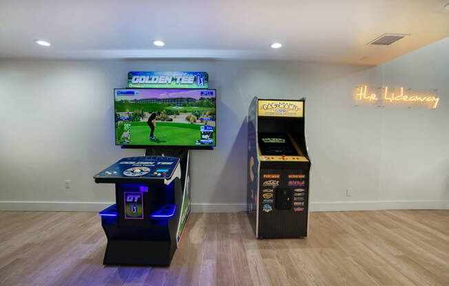 a living room with two video games and a tv at Presidio Palms Apartments, Tucson