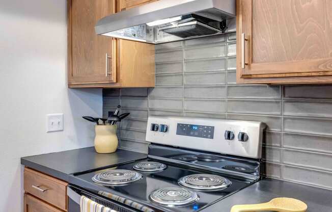 a kitchen with wood cabinets and a stove top oven