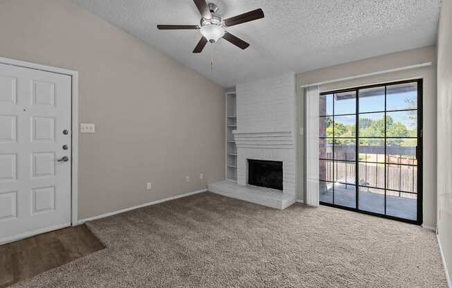 A room with a fireplace and a ceiling fan.