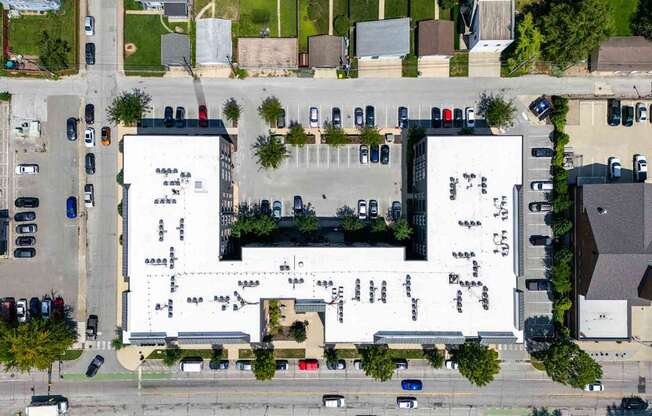 A large white building with a parking lot in front.