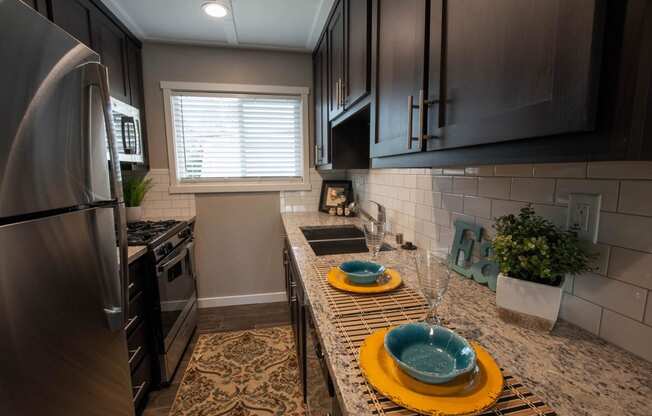 Kitchen with granite counters and stainless appliance