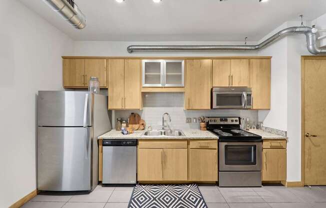 A kitchen with wooden cabinets and stainless steel appliances.