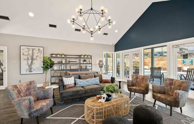 a living room with couches and chairs and a chandelier