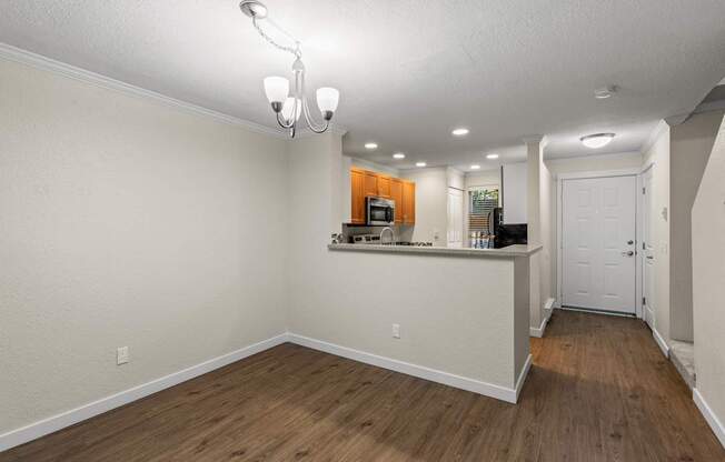 A room with a bar area and a door.