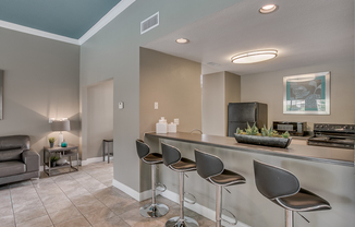 View of Resident Clubhouse, Showing Community Kitchen, Breakfast Bar, and Bar Stools at The Regatta Apartments