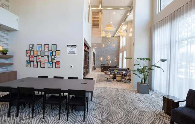 a conference room with a large table and chairs and a large window