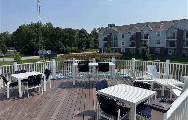 A deck with chairs and tables at Andover Pointe Apartment Homes, La Vista, NE, 68138