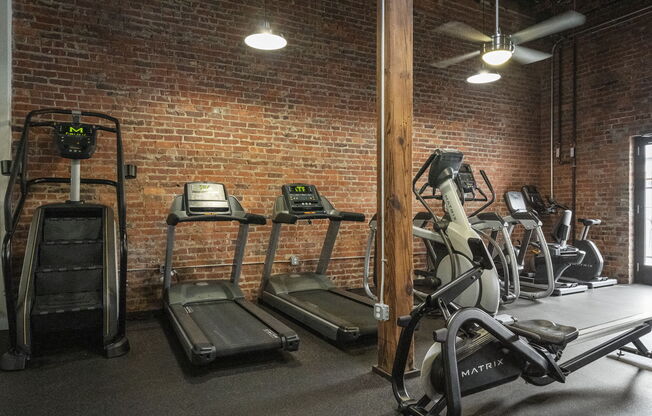 a gym with treadmills and ellipticals