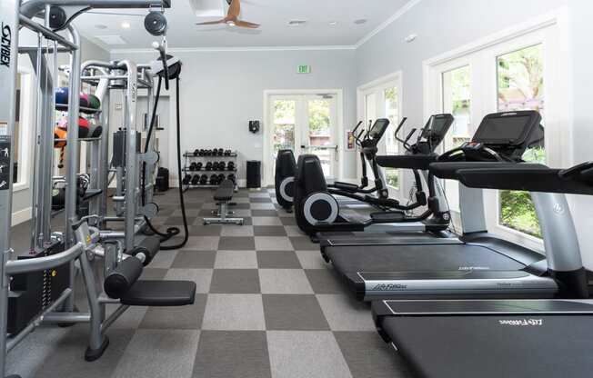 Apartments for Rent in Chino Hill CA - Spacious Fitness Center with Stylish Interior and Various Gym Equipment