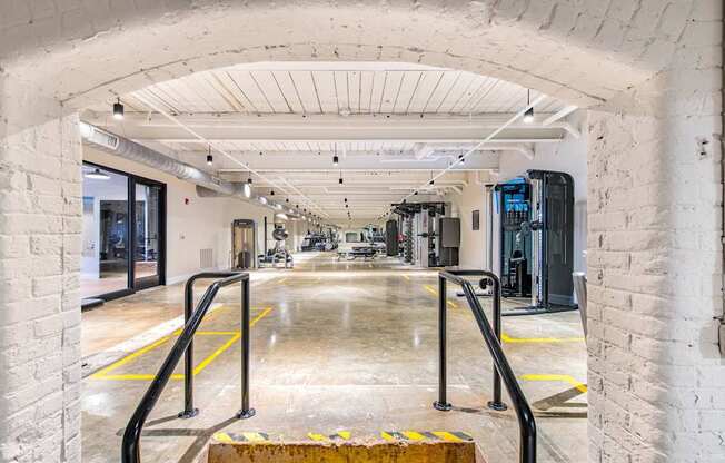 A white brick tunnel with a yellow line on the ground.