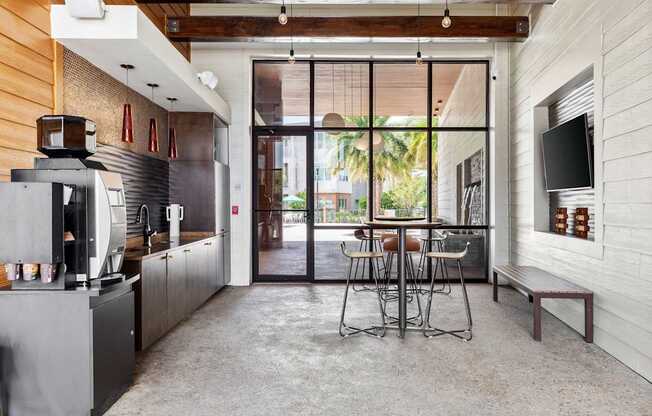 A modern kitchen with a dining table and chairs.