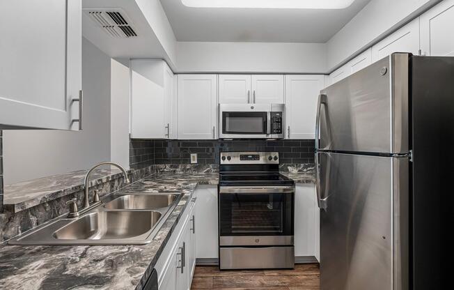 a large kitchen with stainless steel appliances