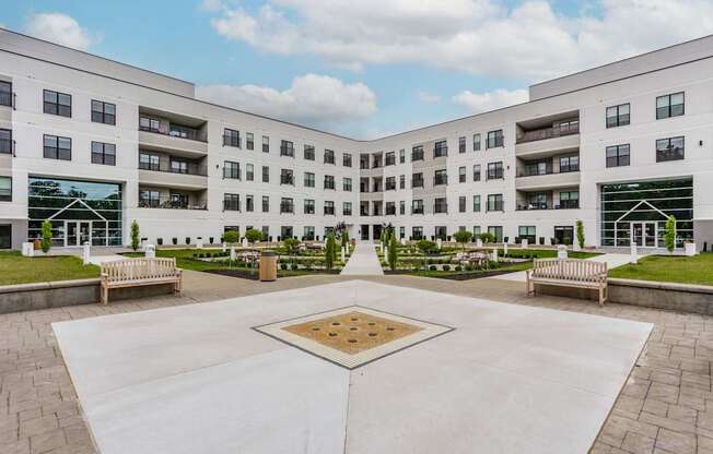 A courtyard with a square in the middle surrounded by apartment buildings.