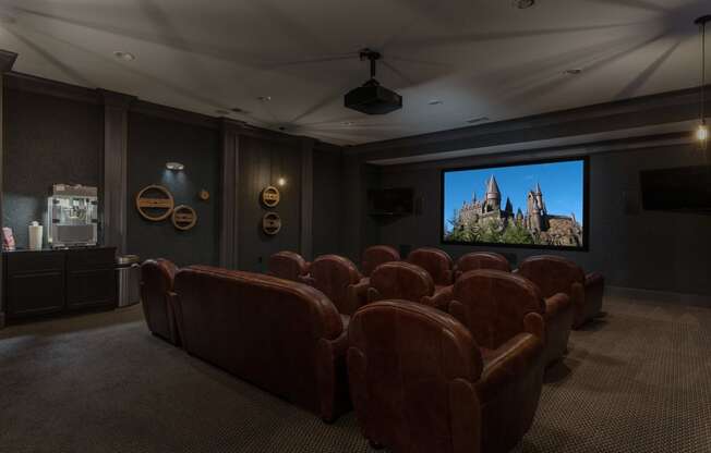 a large screening room with leather seats and a projector screen at Hayden Lofts, Dublin, OH