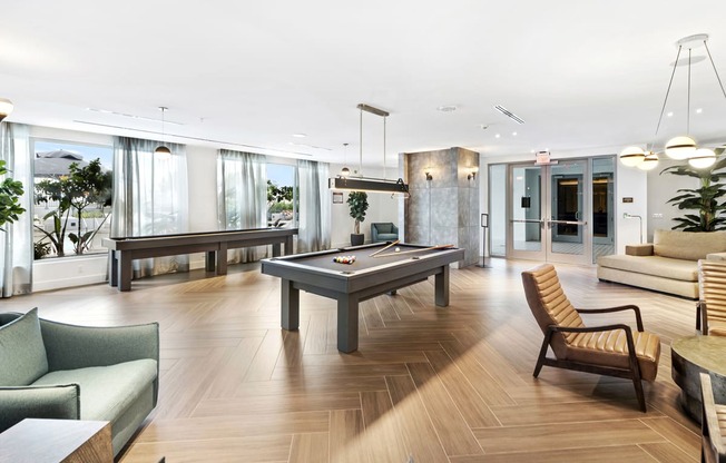 a living room filled with furniture and a pool table