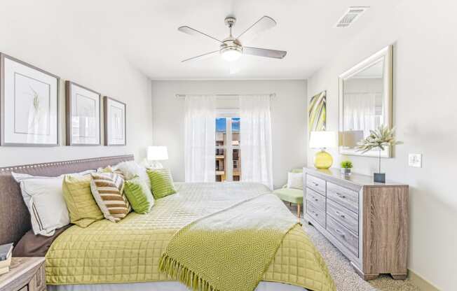 a bedroom with a bed and a ceiling fan