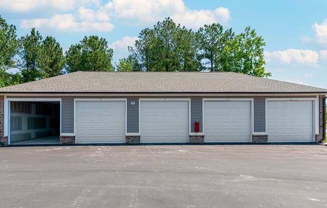 a garage with white doors and a parking lot