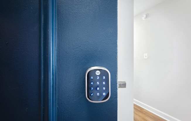 a blue door with smart lock at Roosevelt Towers Apartments, Falls Church, Virginia