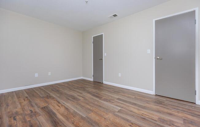 a large empty room with a wooden floor