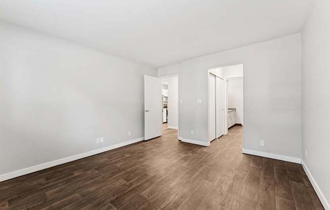 A room with wooden floors and white walls.