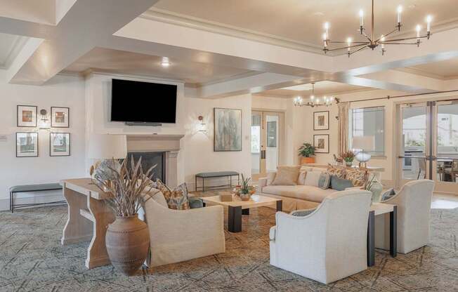 A living room with a fireplace and a television on the wall.