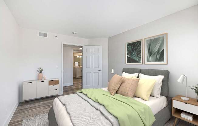 A bedroom with a bed, nightstand, and a cabinet.