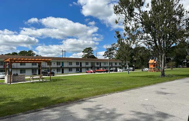 the building where the motel is located has a park in front of it