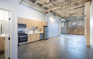 an empty kitchen and living room in a loft