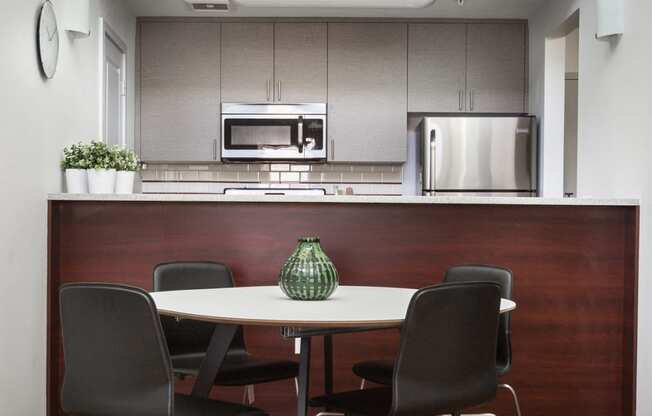 Table and chairs in front of kitchen and counter top