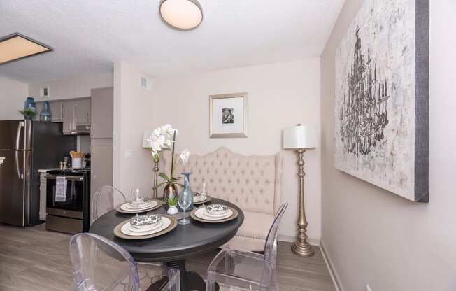 a dining room with a table and chairs and a kitchen