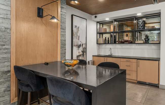 a dining room with a table and chairs and a kitchen