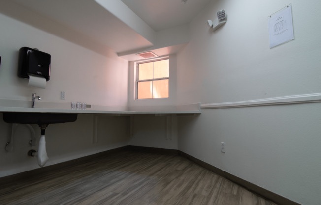 A room with a desk and a window.