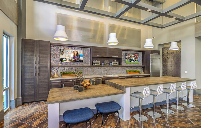 A modern kitchen with a wooden island and bar stools.