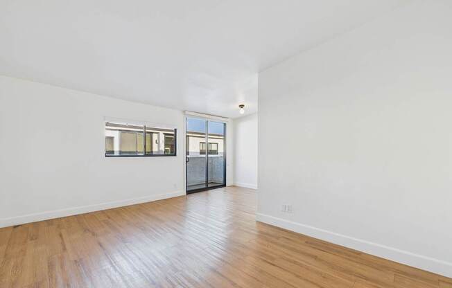 A room with wooden floors and white walls.