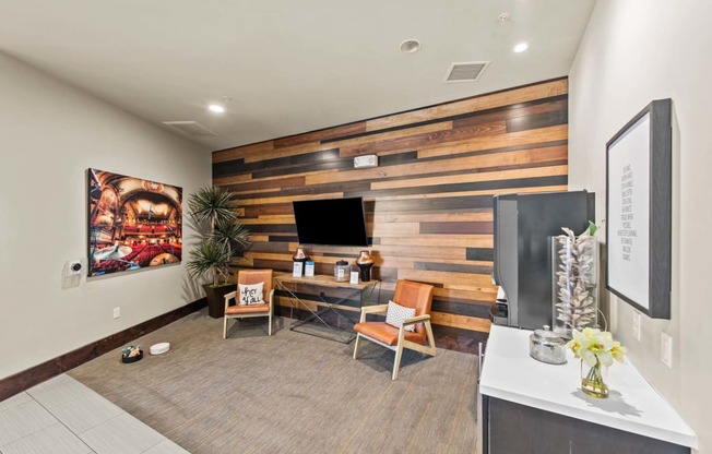 a home office with a wooden wall and a television