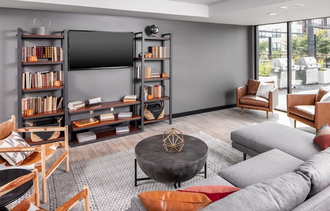 a living room with a gray couch and a coffee table at Maven on Broadway, Rochester, MN