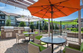 a patio with tables chairs and umbrellas